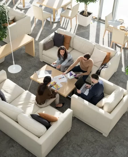 Group of young auditors of high tech corporation discussing documents